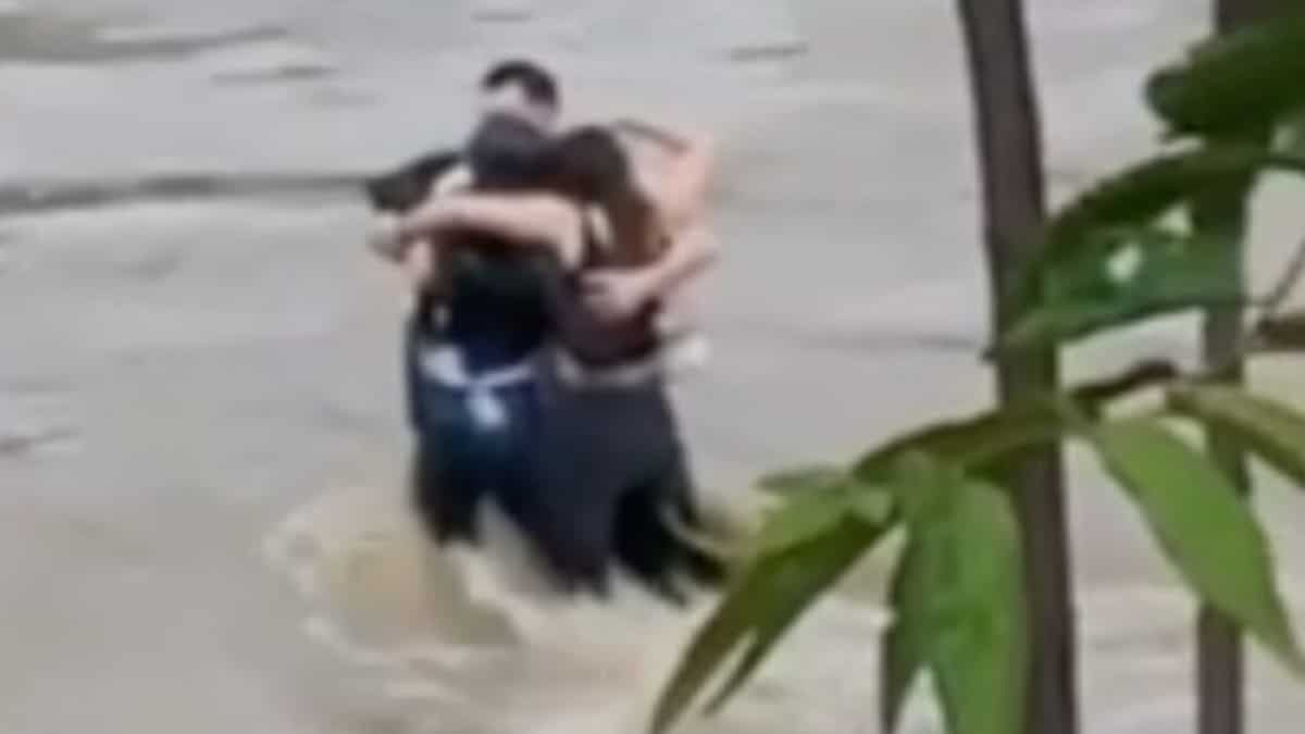 ‘Heartbreaking’: Three associates seen hugging earlier than being swept away by floodwaters